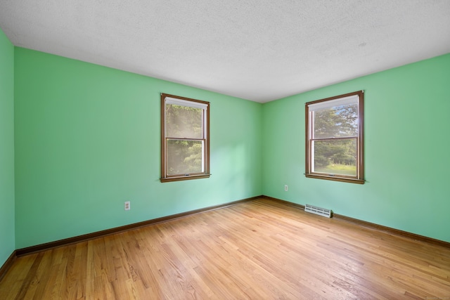229 Flanders Rd, Southington, CT 06489 - empty room featuring wood finished floors and a textured ceiling