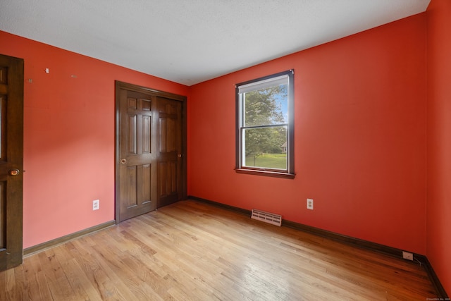 229 Flanders Rd, Southington, CT 06489 - unfurnished bedroom featuring light wood-style flooring and a closet