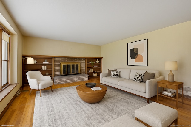 229 Flanders Rd, Southington, CT 06489 - living area featuring wood finished floors and a brick fireplace