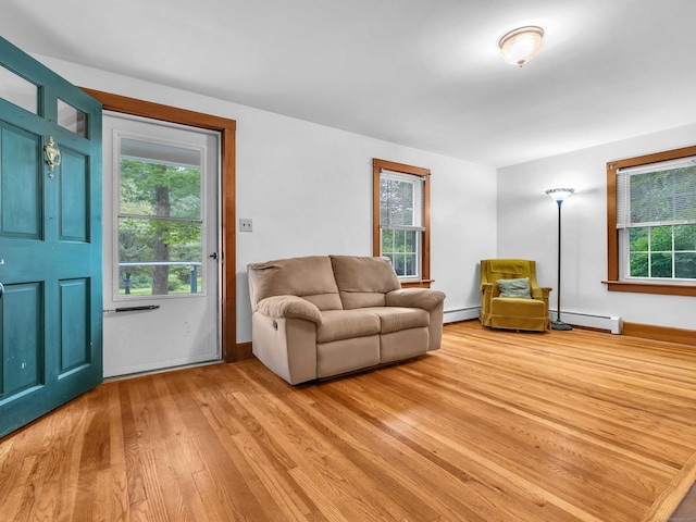 79 E Pattagansett Rd, East Lyme, CT 06357 - living room featuring a baseboard heating unit, light wood finished floors, and plenty of natural light