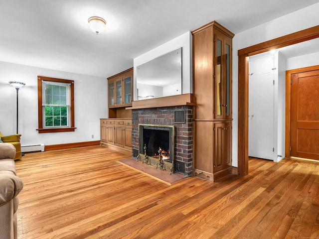 79 E Pattagansett Rd, East Lyme, CT 06357 - living area featuring light wood-style flooring, a baseboard radiator, and a fireplace