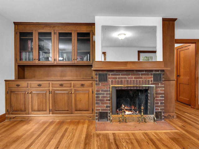 79 E Pattagansett Rd, East Lyme, CT 06357 - unfurnished living room featuring light wood-style flooring and a fireplace