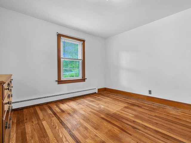 79 E Pattagansett Rd, East Lyme, CT 06357 - empty room with a baseboard radiator and wood finished floors