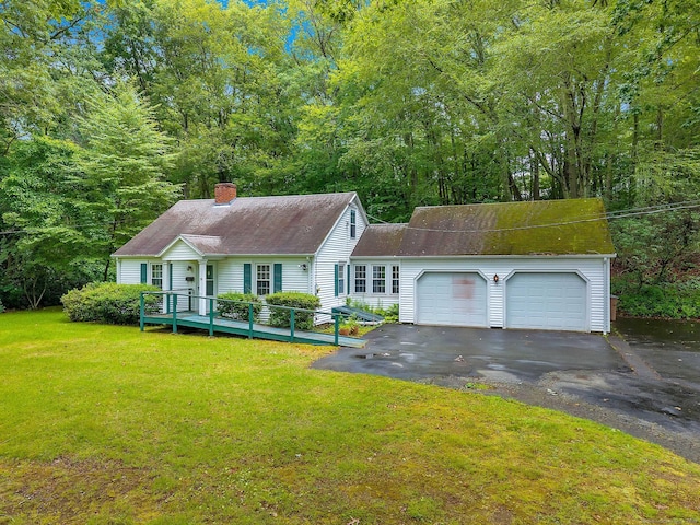 79 E Pattagansett Rd, East Lyme, CT 06357 - view of front of home featuring asphalt driveway, a chimney, a front yard, a garage, and a deck