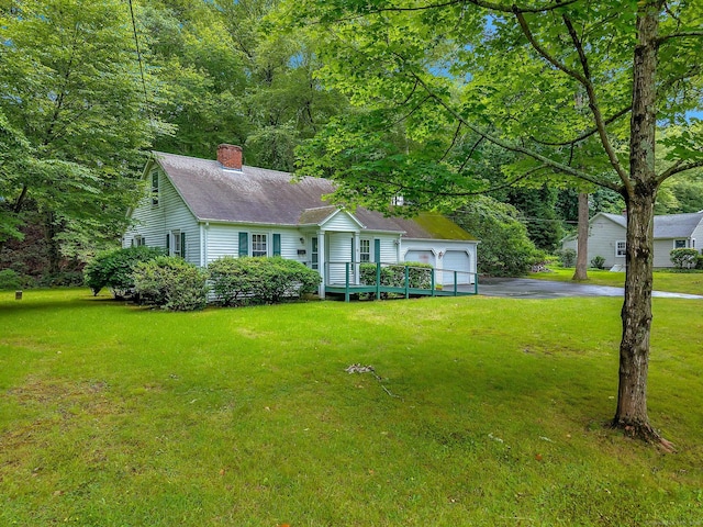79 E Pattagansett Rd, East Lyme, CT 06357 - view of front of home with a chimney, a front lawn, a shingled roof, and asphalt driveway