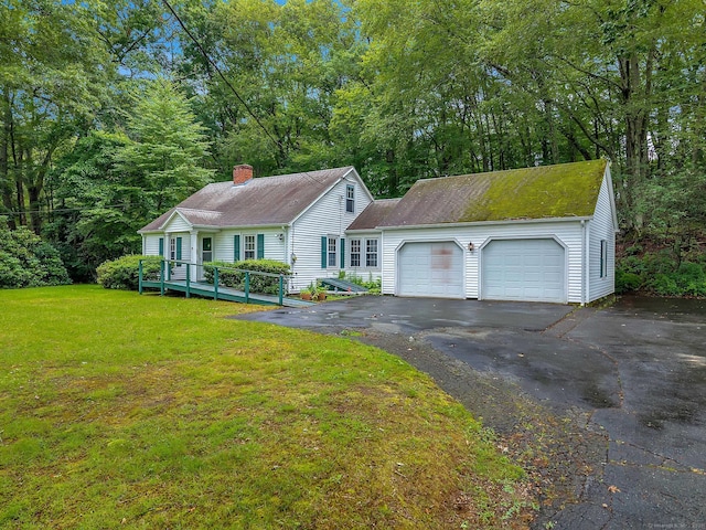 79 E Pattagansett Rd, East Lyme, CT 06357 - view of front of property featuring a chimney, a front lawn, driveway, an attached garage, and a shingled roof