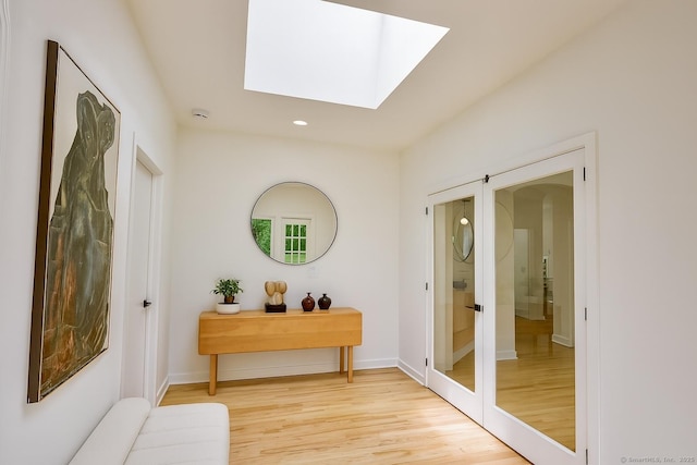 765 Durham Rd, Guilford, CT 06437 - entryway featuring a skylight, light wood-type flooring, recessed lighting, and arched walkways