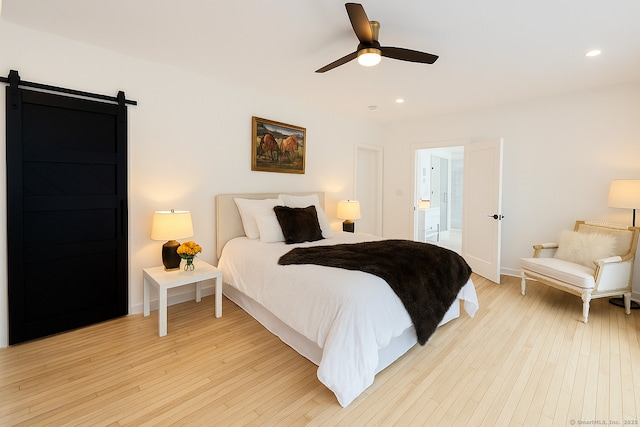 765 Durham Rd, Guilford, CT 06437 - bedroom with recessed lighting, light wood-type flooring, a barn door, and a ceiling fan