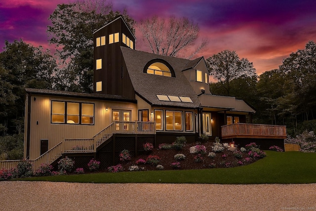 765 Durham Rd, Guilford, CT 06437 - back of house at dusk featuring stairs, a yard, a wooden deck, and a shingled roof