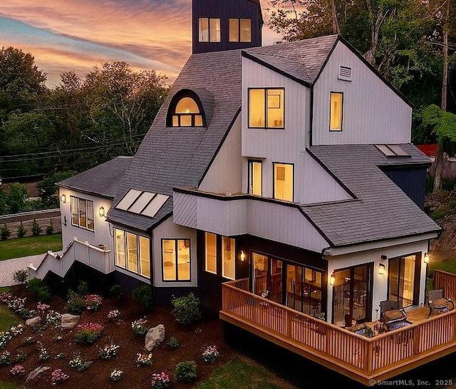 765 Durham Rd, Guilford, CT 06437 - back of house at dusk featuring roof with shingles and a deck