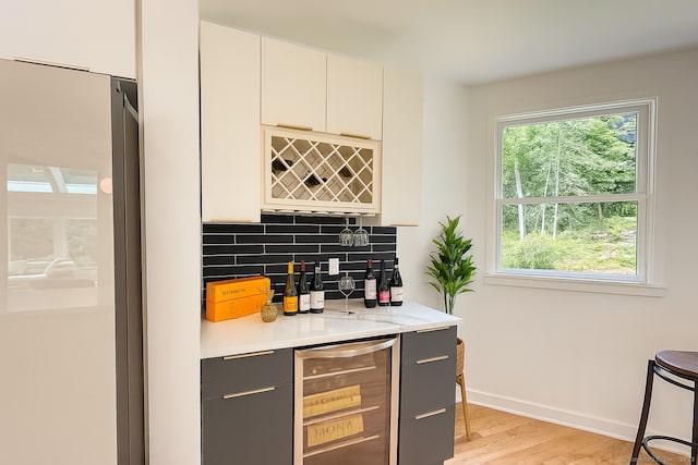 765 Durham Rd, Guilford, CT 06437 - indoor dry bar with wine cooler, freestanding refrigerator, healthy amount of natural light, and decorative backsplash