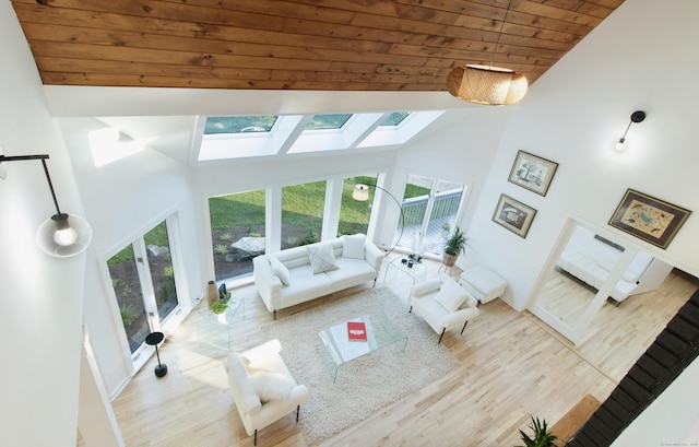 765 Durham Rd, Guilford, CT 06437 - living room with high vaulted ceiling, a skylight, wooden ceiling, and wood finished floors