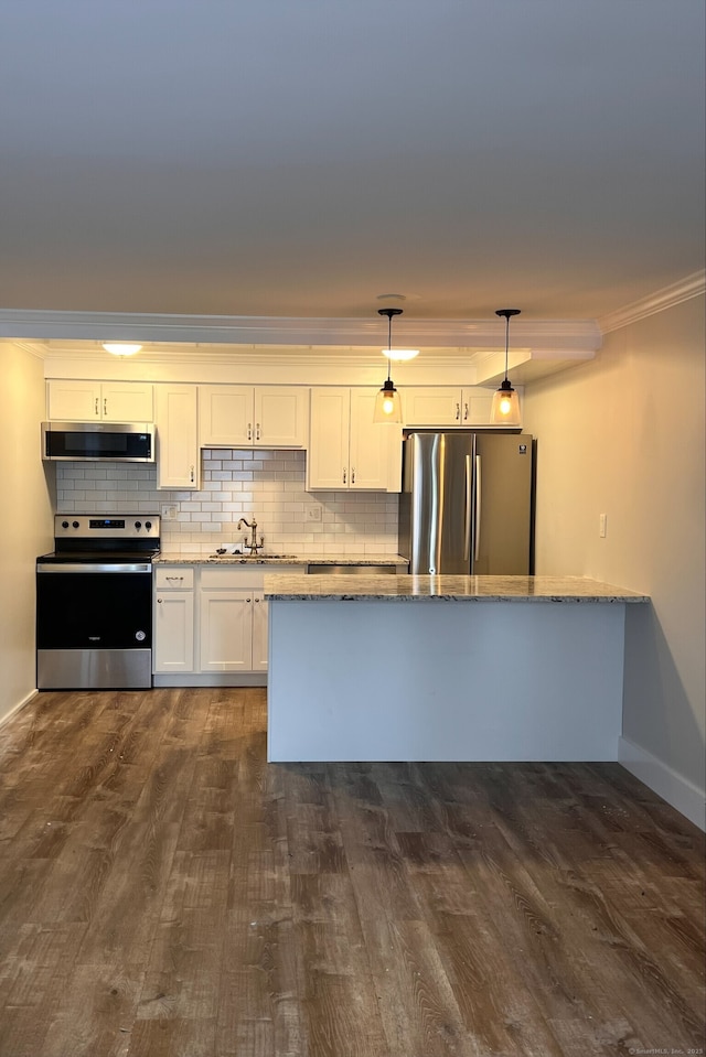 8 Hamre Ln Unit A, Branford, CT 06405 - kitchen with stainless steel appliances, light stone counters, dark wood finished floors, ornamental molding, and white cabinetry