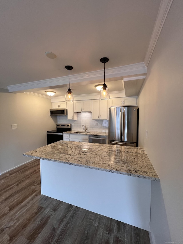 8 Hamre Ln Unit A, Branford, CT 06405 - kitchen with stainless steel appliances, ornamental molding, white cabinetry, dark wood-style flooring, and a peninsula