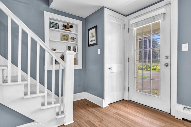 18 Lynde St, Old Saybrook, CT 06475 - entryway featuring stairs, wood finished floors, and a baseboard radiator