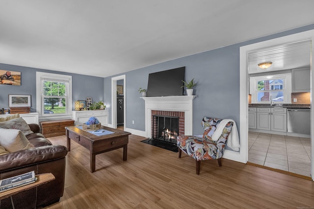 18 Lynde St, Old Saybrook, CT 06475 - living area featuring a brick fireplace and light wood-style flooring