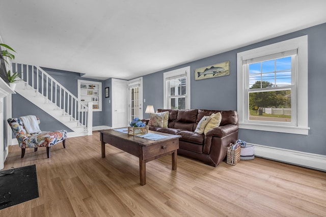 18 Lynde St, Old Saybrook, CT 06475 - living area featuring light wood-type flooring, stairway, and a baseboard heating unit