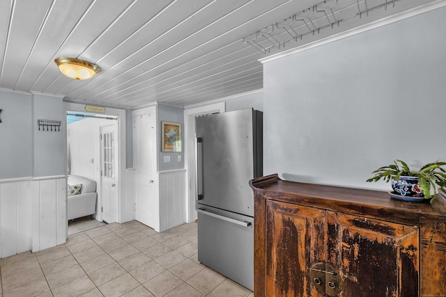 18 Lynde St, Old Saybrook, CT 06475 - kitchen with freestanding refrigerator, light tile patterned floors, and a wainscoted wall