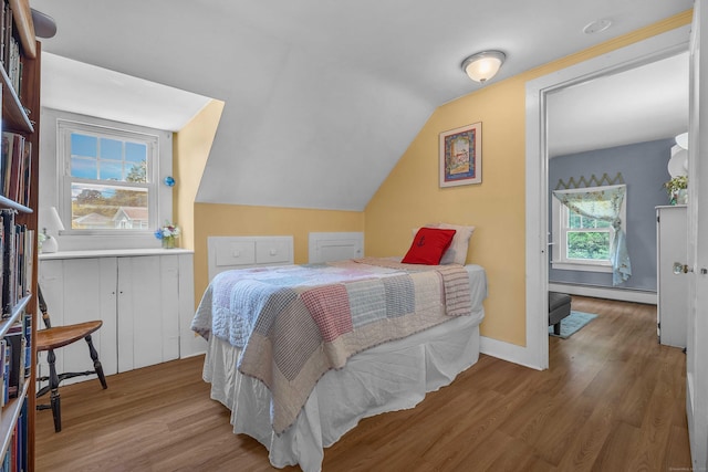 18 Lynde St, Old Saybrook, CT 06475 - bedroom featuring baseboard heating, wood finished floors, and vaulted ceiling