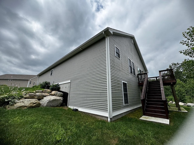 4 Skylark Ln Unit 4, Killingly, CT 06239 - view of side of property with stairway, a wooden deck, and a lawn