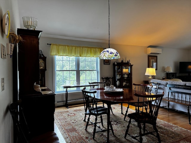 4 Skylark Ln Unit 4, Killingly, CT 06239 - dining space with a wall mounted air conditioner, wood finished floors, a baseboard radiator, and ornamental molding