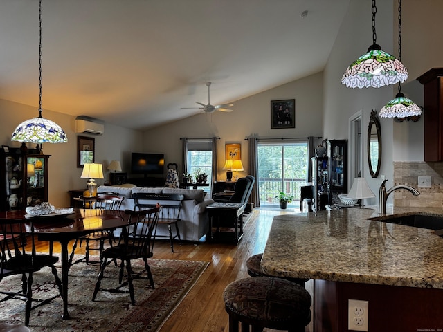 4 Skylark Ln Unit 4, Killingly, CT 06239 - dining space with a wall mounted AC, vaulted ceiling, ceiling fan, and dark wood-style flooring