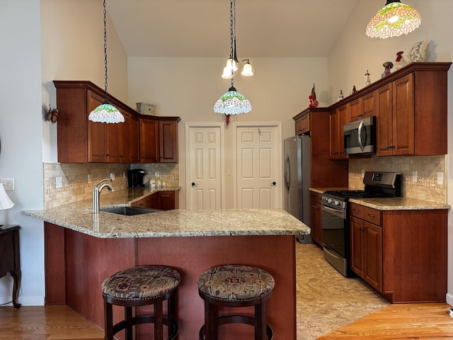 4 Skylark Ln Unit 4, Killingly, CT 06239 - kitchen with stainless steel appliances, a peninsula, decorative backsplash, and a breakfast bar