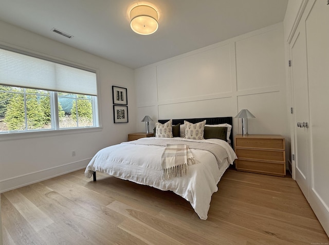 785 Post Rd E Unit 301, Westport, CT 06880 - bedroom featuring light wood-type flooring and a decorative wall