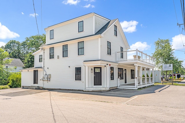 44 Williams St, Stonington, CT 06379 - view of front of property featuring a balcony, uncovered parking, and covered porch