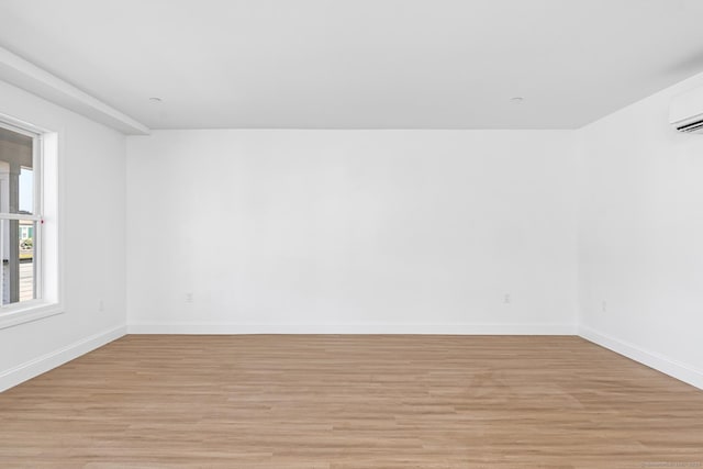 44 Williams St, Stonington, CT 06379 - unfurnished room with light wood-type flooring and a wall mounted air conditioner