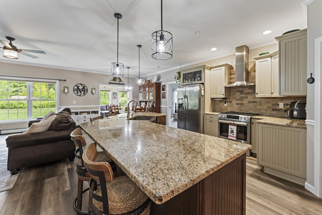 32 Mockingbird Dr Unit 32, Killingly, CT 06239 - kitchen featuring stainless steel appliances, wall chimney range hood, open floor plan, crown molding, and a ceiling fan