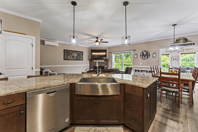32 Mockingbird Dr Unit 32, Killingly, CT 06239 - kitchen with stainless steel dishwasher, a wall mounted AC, ceiling fan, open floor plan, and a fireplace