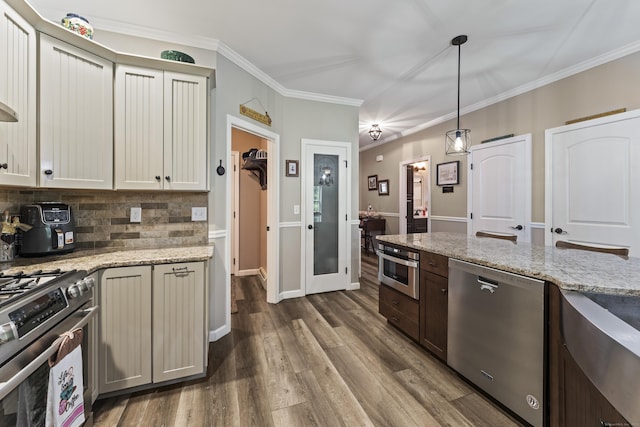 32 Mockingbird Dr Unit 32, Killingly, CT 06239 - kitchen with stainless steel appliances, dark wood finished floors, decorative backsplash, light stone countertops, and hanging light fixtures