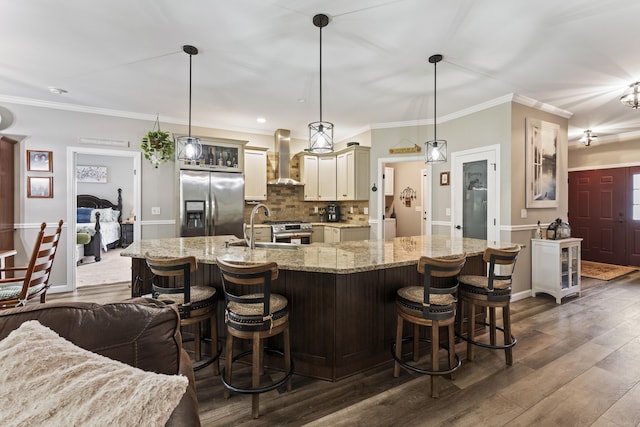 32 Mockingbird Dr Unit 32, Killingly, CT 06239 - kitchen with stainless steel appliances, wall chimney range hood, glass insert cabinets, tasteful backsplash, and dark wood-type flooring