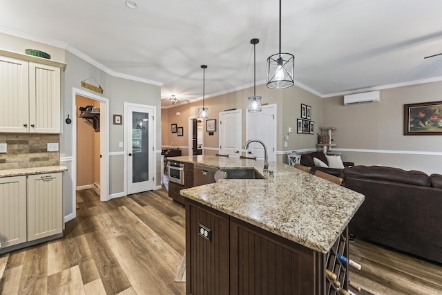 32 Mockingbird Dr Unit 32, Killingly, CT 06239 - kitchen featuring a wall mounted AC, dark wood finished floors, backsplash, an island with sink, and decorative light fixtures