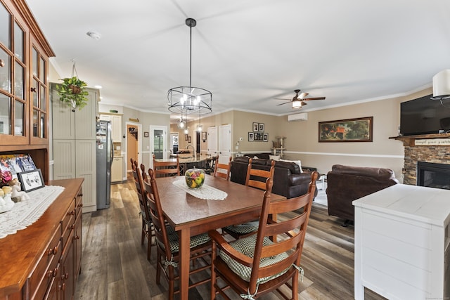 32 Mockingbird Dr Unit 32, Killingly, CT 06239 - dining area featuring a ceiling fan, dark wood finished floors, ornamental molding, a wall mounted AC, and a fireplace