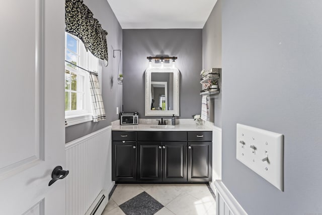 32 Mockingbird Dr Unit 32, Killingly, CT 06239 - bathroom featuring vanity, wainscoting, tile patterned flooring, and a baseboard radiator