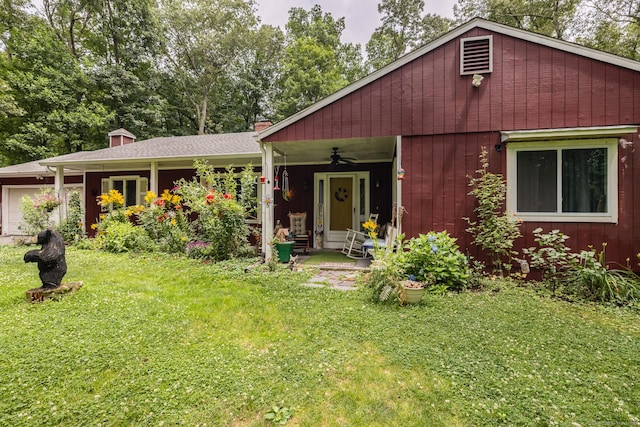 93 Kettletown Woods Rd, Southbury, CT 06488 - view of front of house featuring a ceiling fan, a front yard, a garage, and a chimney
