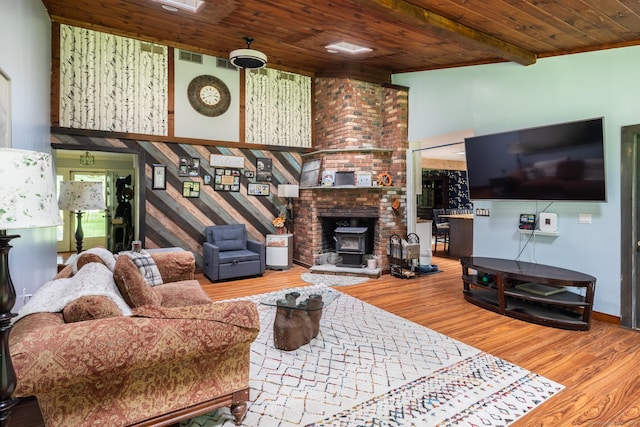 93 Kettletown Woods Rd, Southbury, CT 06488 - living area with a wooden ceiling with exposed beams, wood finished floors, a wood stove, and a high ceiling
