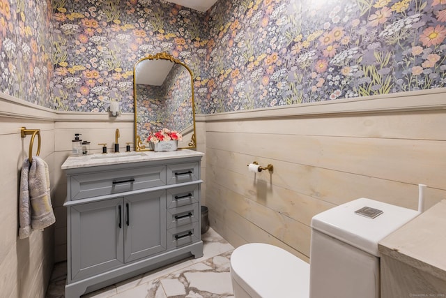 93 Kettletown Woods Rd, Southbury, CT 06488 - half bathroom featuring wallpapered walls, a wainscoted wall, marble finish floors, and vanity