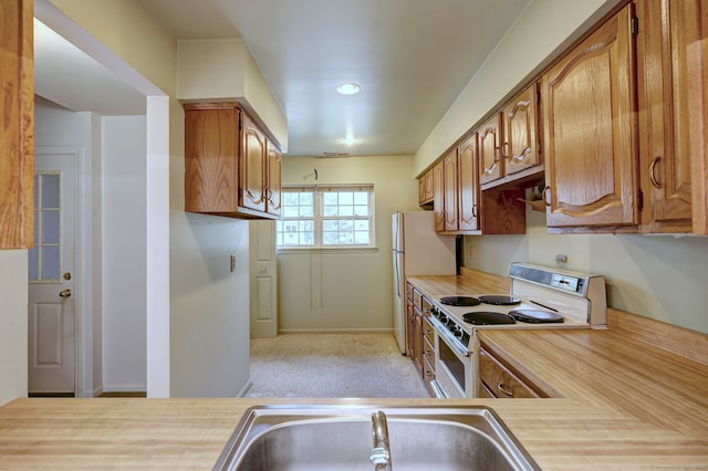 25 Janet Cir Unit F, Bridgeport, CT 06606 - kitchen with white appliances, light countertops, and brown cabinets