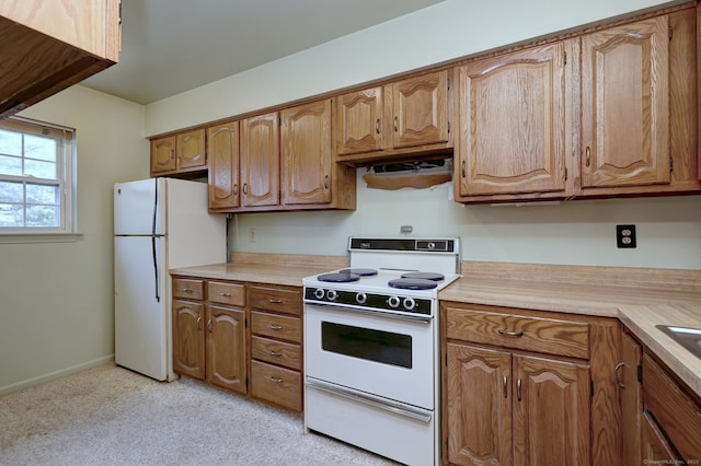25 Janet Cir Unit F, Bridgeport, CT 06606 - kitchen with white appliances, light countertops, brown cabinets, and light carpet