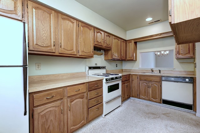 25 Janet Cir Unit F, Bridgeport, CT 06606 - kitchen with white appliances, light countertops, a chandelier, light carpet, and brown cabinets