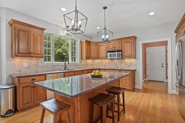 36 Blueberry Ln, Canton, CT 06019 - kitchen with a breakfast bar area, a chandelier, light wood finished floors, appliances with stainless steel finishes, and recessed lighting