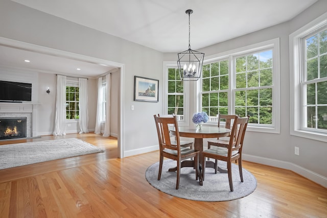 36 Blueberry Ln, Canton, CT 06019 - dining room with light wood-type flooring, a chandelier, a glass covered fireplace, and recessed lighting
