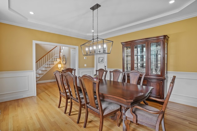36 Blueberry Ln, Canton, CT 06019 - dining room with wainscoting, a raised ceiling, stairs, a chandelier, and light wood-type flooring