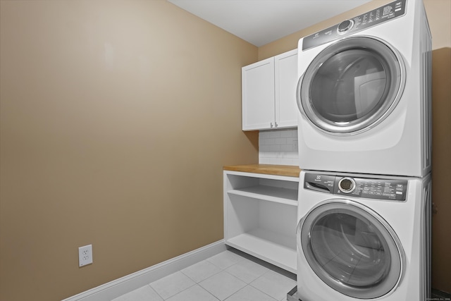 36 Blueberry Ln, Canton, CT 06019 - washroom featuring cabinet space, estacked washer and dryer, and light tile patterned floors
