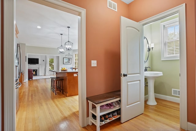 36 Blueberry Ln, Canton, CT 06019 - hallway with light wood-style floors and a chandelier