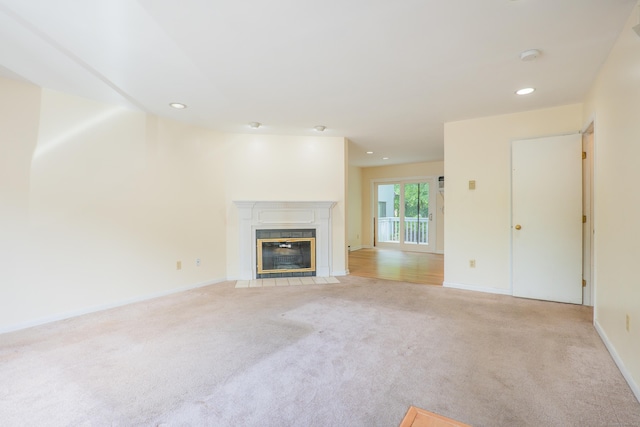 19 Somers St Unit D1, Danbury, CT 06810 - unfurnished living room with light carpet, a fireplace with flush hearth, and recessed lighting