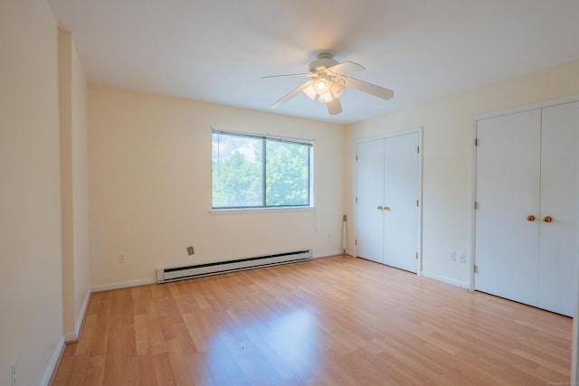 19 Somers St Unit D1, Danbury, CT 06810 - unfurnished bedroom featuring a baseboard heating unit, multiple closets, light wood-style floors, and ceiling fan
